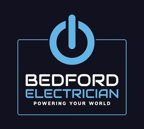 Logo featuring a blue power button icon above the words "Bedford Electrician" in white and light blue letters. The phrase "Powering Your World" is written below in smaller white text, all set against a dark background.